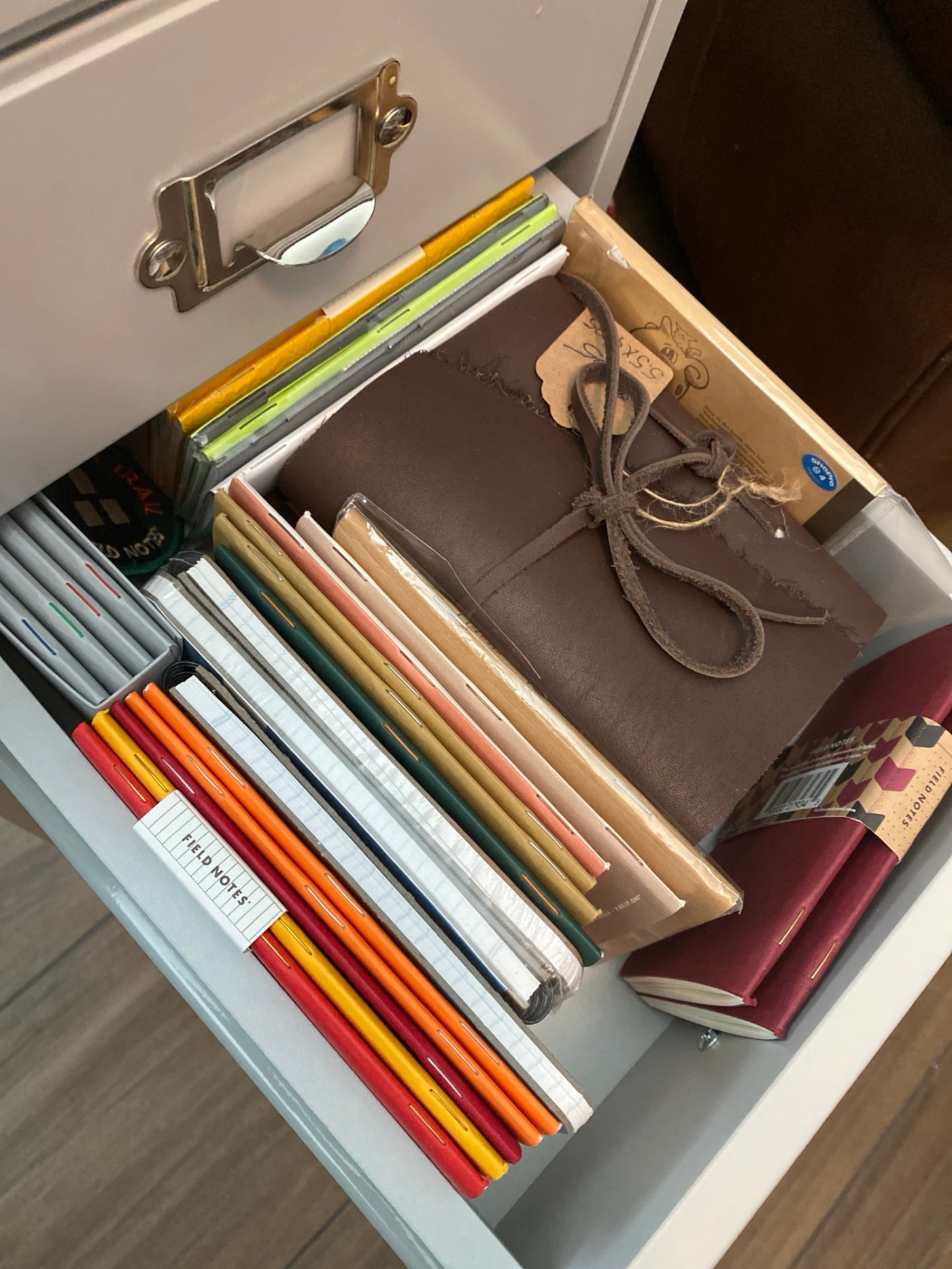 A drawer of pocket sized notebooks.