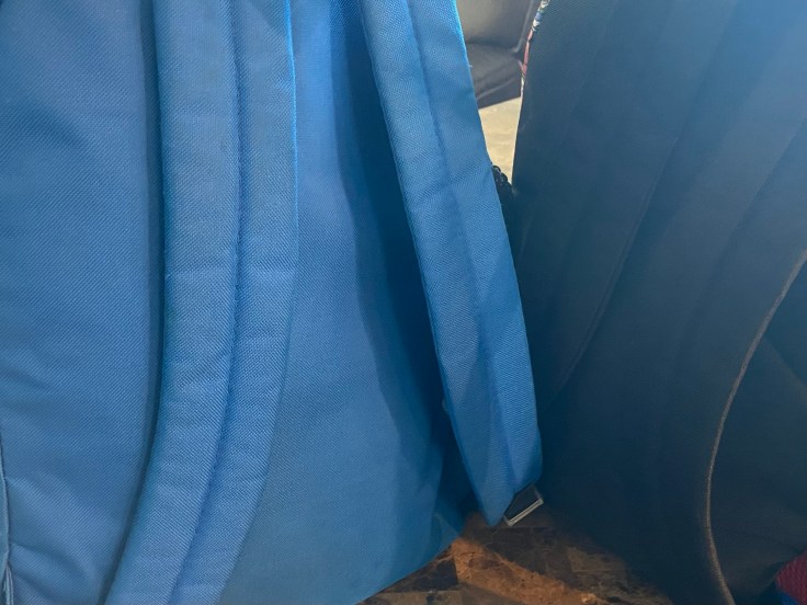 The straps of two children's backpacks. 