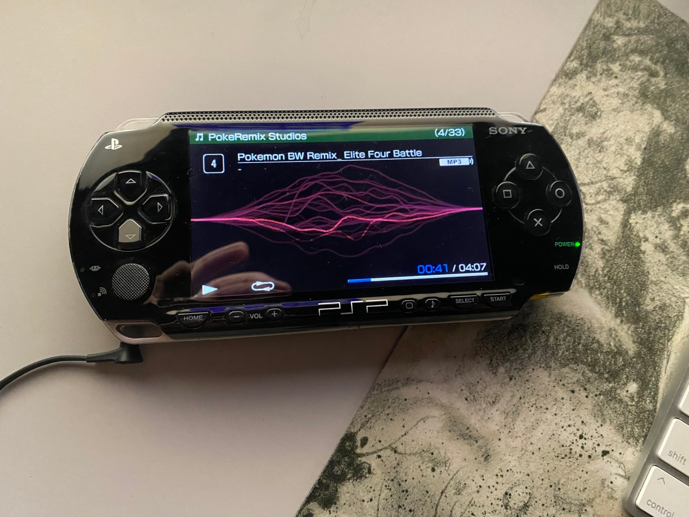 A PSP V1 showing a screen playing music