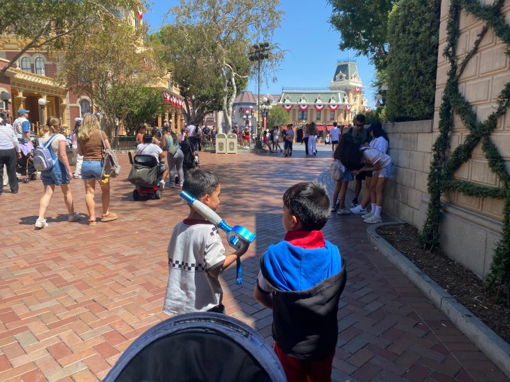 A pair of twin boys walking around Disneyland in Sora and Roxas cosplay from Kingdom Hearts. 