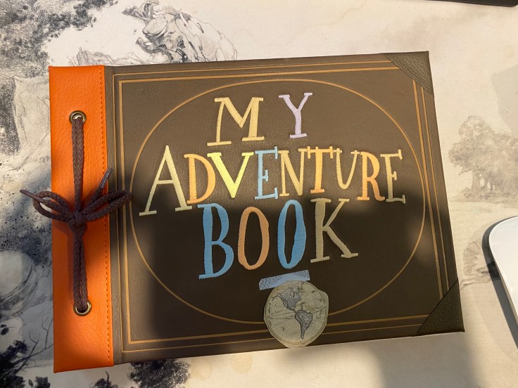 The cover to a notebook like Pixar's UP entitled "My Adventure Book."