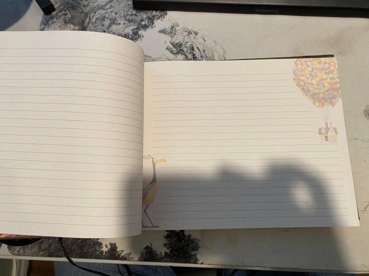 The inside to a notebook like Pixar's UP entitled "My Adventure Book."